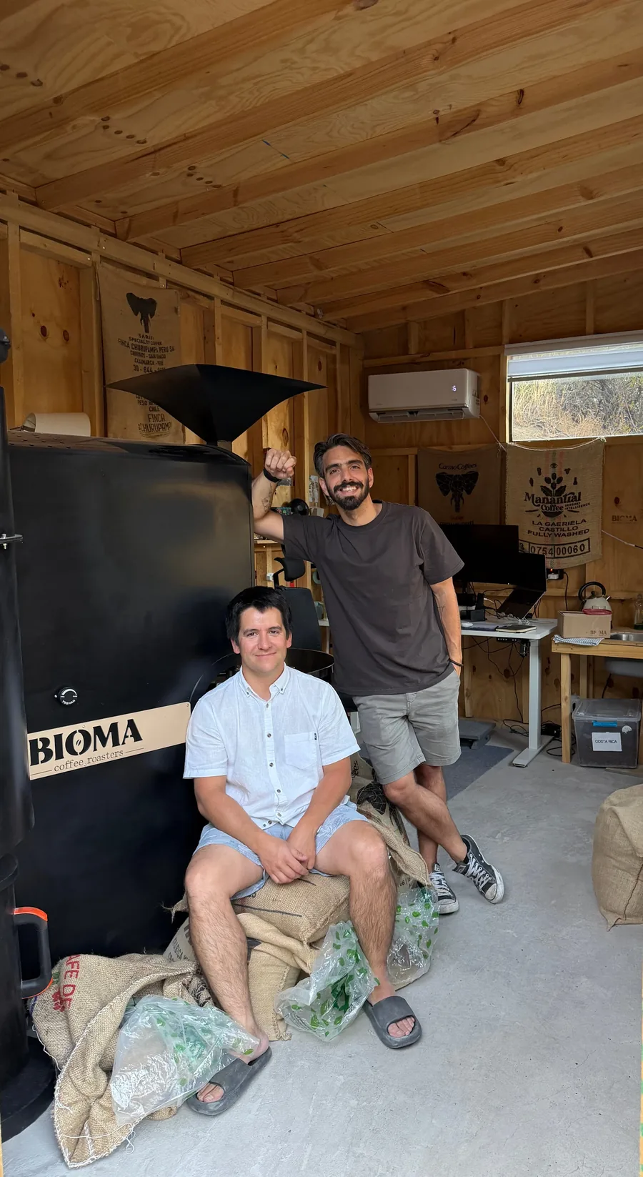 The Bioma Coffee founders beside their roaster